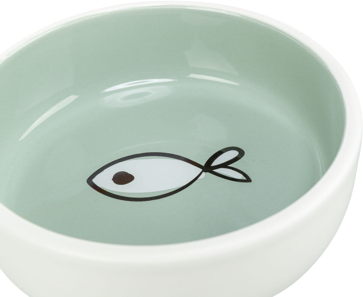 Runde, weiß-grüne Schüssel mit einem schwarzen Fischmotiv auf dem Boden.