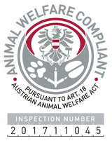 Rundes Logo mit Adler und Text "Animal Welfare Compliant" und "Pursuant to Art. 18 Austrian Animal Welfare Act".