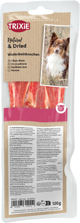 Verpackung mit getrocknetem Wadenbeinknochen als Hundefutter, Label zeigt Hund und Informationen in mehreren Sprachen.