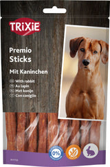 Verpackung von Trixie Premio Sticks mit Kaninchen, daneben Bild eines Hundes und Symbole für zuckerzusatzfrei und glutenfrei.