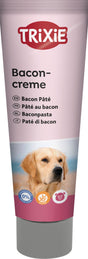 Eine rosa Tube mit der Aufschrift "Baconcreme" und verschiedenen Sprachen, darunter ein Bild eines Hundes.
