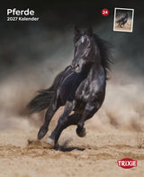 Schwarzes Pferd galoppiert durch sandige Landschaft, Kalender "Pferde 2027" und TRIXIE Logo sichtbar.