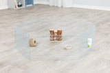 Metall-Laufstall auf Holzboden mit Futternapf, Wasserflasche, Holzspielzeug und knabberbarem Ball innen.