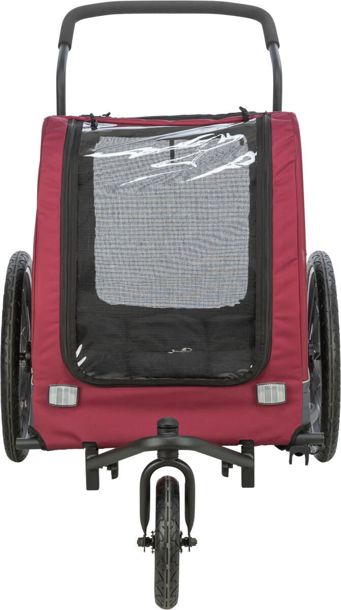 Roter Fahrradanhänger mit schwarzem Netzstoff an der Vorderseite und zwei großen Reifen, von der Rückseite gesehen.