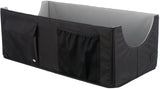 Schwarze, rechteckige Box mit grauem Innenraum, zwei Netz- und einer Klapptasche an der Seite.