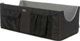 Rechteckige schwarze Box mit grauem Innenfutter, zwei Außentaschen und seitlichem Griff.