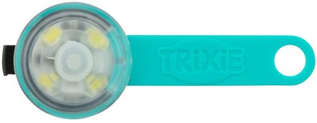 Rundes, transparentes Leuchtartikel mit blauer Halterung, Aufschrift "TRIXIE", vier gelbe LEDs sind sichtbar.