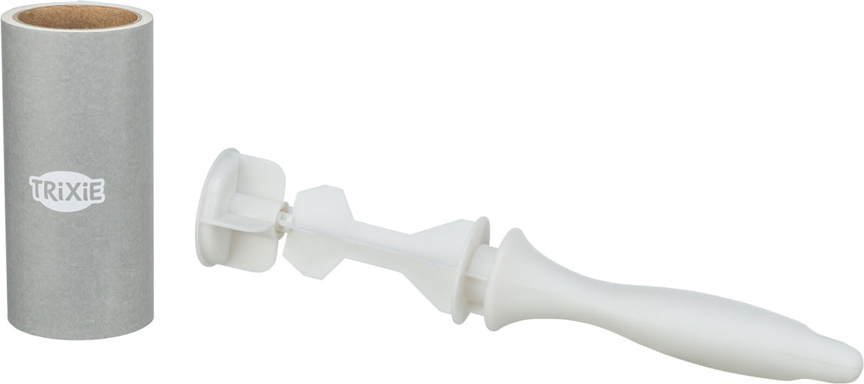Grauer Zylinder mit "TRIXIE"-Logo neben einem weißen zylinderförmigen Plastikgriff mit Schaufelform.