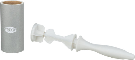Grauer Zylinder mit "TRIXIE"-Logo neben einem weißen zylinderförmigen Plastikgriff mit Schaufelform.