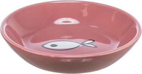 Rosa Schüssel mit Fischmotiv auf dem Boden, runde Form und glänzende Oberfläche.