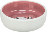Weiße Keramikschale mit rosa Innenfläche und Fischmotiv am Boden.