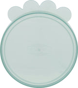 Transparenter, runder Plastikdeckel mit Wellenmustererhöhung und dem Aufdruck "TRIXIE" in der Mitte.