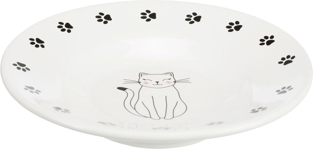 Weiße Schüssel mit schwarzem Pfotenmuster und einer lächelnden Katze in der Mitte.