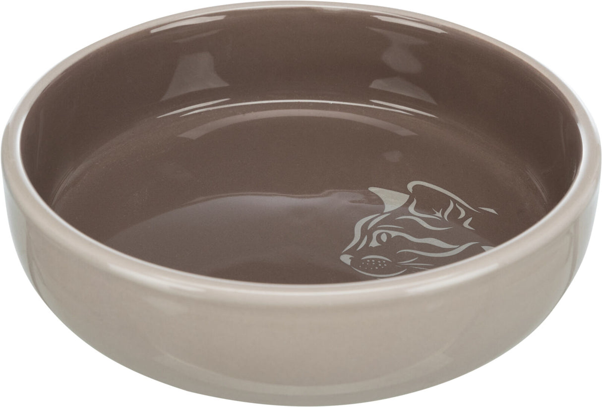 Braune, runde Schale mit einem Katzenmotiv auf dem Boden, glänzende Oberfläche.