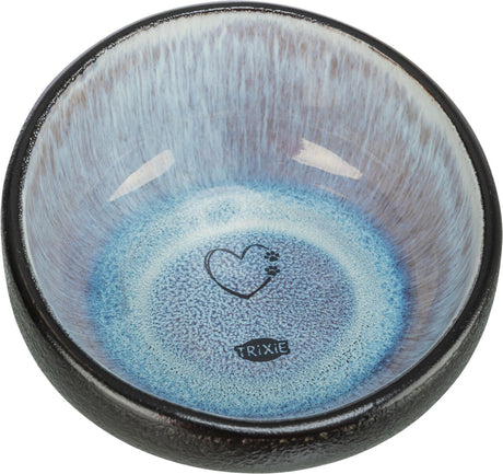 Runde Schale mit blauem Innenbereich, Herzsymbol und dem Text "Trixie" in der Mitte, schwarzer Rand.