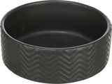 Runde, schwarze Schale mit Zickzackmuster an den Seiten, glatt und gleichmäßig gefärbt.