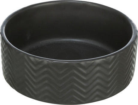 Runde, schwarze Schale mit Zickzackmuster an den Seiten, glatt und gleichmäßig gefärbt.