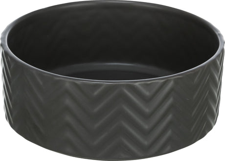 Runde, schwarze Schale mit Zickzack-Muster auf der Außenseite.