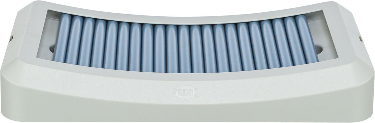 Rechteckiges, graues Gerät mit blauen, parallelen Rillen in der Mitte, sichtbares "Trixie"-Logo.
