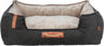 Hundebett mit dunkelgrauem Stoffbezug und heller, weicher Innenseite, vorne mit braunem Lederdetail und Seilgriff.