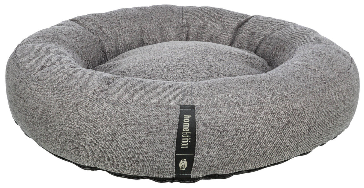 Graues, rundes Haustierbett mit schwarzem Etikett der Marke "homeEdition" von "Trixie".