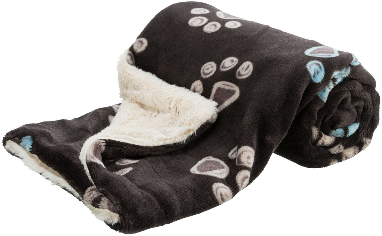 Schwarze Decke mit beigefarbenem, flauschigem Innenfutter und hellen Pfotenabdruckmustern.