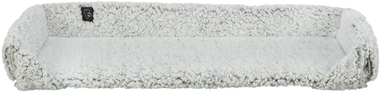 Langes rechteckiges, flauschiges, graues Kissen mit erhöhten Rändern und einem kleinen schwarzen Etikett.