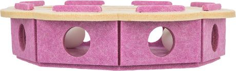 Rundes, pinkes Filzspielzeug mit Löchern und beigem Teppich auf der Oberseite, ideal zum Spielen.