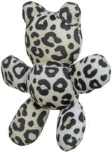Plüschfigur in Form eines Tieres mit schwarz-weißen Leopardenmuster, aus weichem Material.