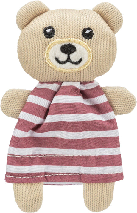 Ein gestrickter Teddybär mit gestreiftem Kleid in Rot und Weiß, hat aufgestickte Augen und ein Lächeln.