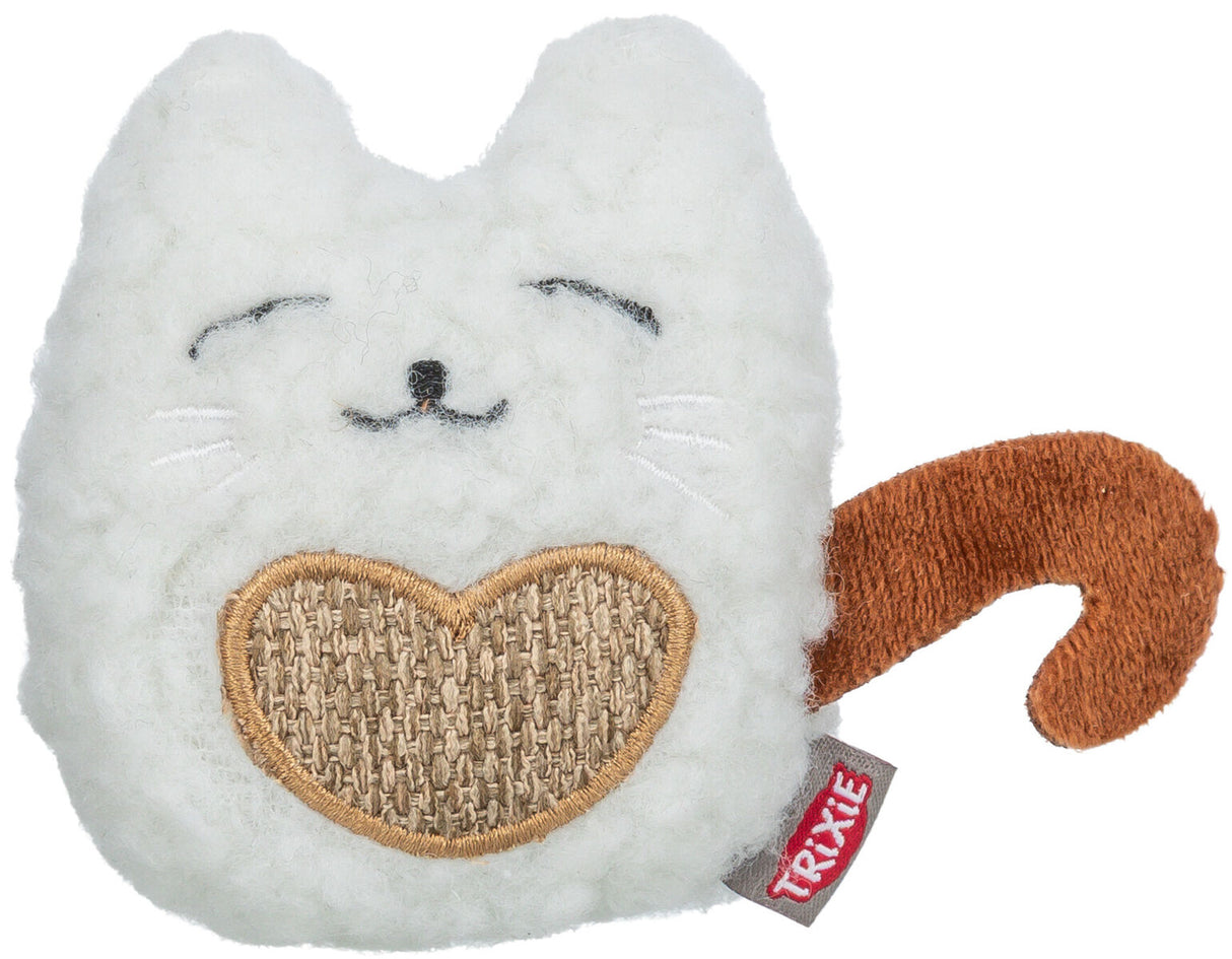 Weißes, katzenförmiges Spielzeug mit braunem Schwanz und herzförmigem Detail, Label "Trixie" sichtbar.