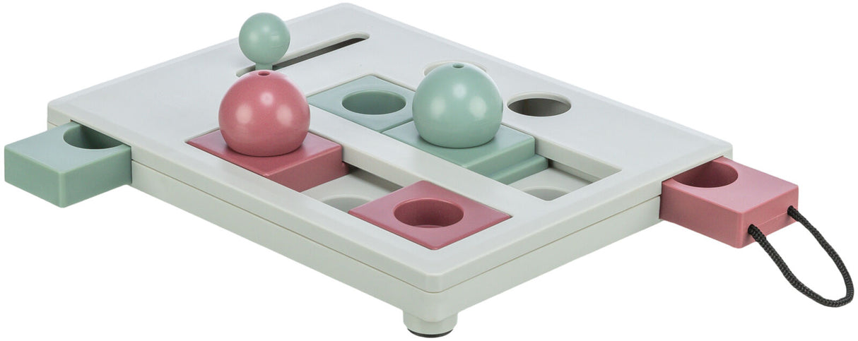 Interaktives Spielzeug mit rosa und grünen Elementen auf einer weißen Basis, Schubladen und bewegliche Teile erkennbar.