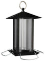 Schwarzes, sechseckiges Vogelhaus aus Metall und Glas mit rundem Aufhängering und silbernen Sitzstangen.