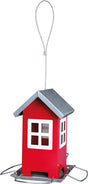Rotes, hausförmiges Vogelhaus mit silbernem Dach und Aufhängeschlaufe, auf Metallboden befestigt.