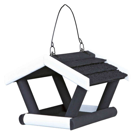 Schwarzes und weißes Vogelhaus in Form eines kleinen Daches mit Haken zum Aufhängen.