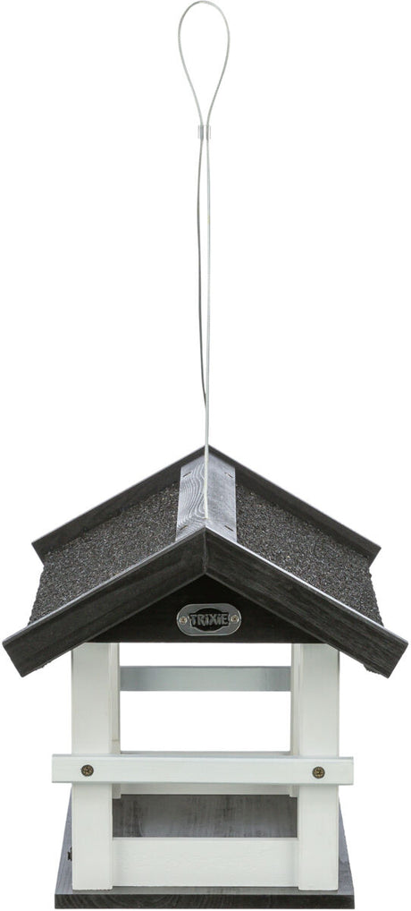 Schwarzes und weißes Vogelhaus mit Satteldach aus Holz, Aufhängung oben, Marke sichtbar "Trixie".