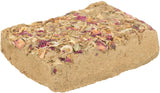 Rechteckiger, beigeer Block mit getrockneten Blumenblättern in Rosa und Orange auf der Oberfläche.