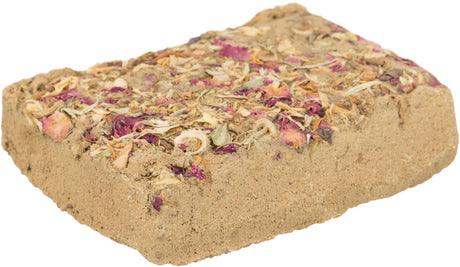 Rechteckiger, beigeer Block mit getrockneten Blumenblättern in Rosa und Orange auf der Oberfläche.