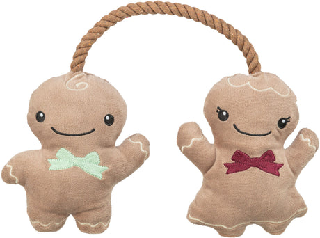 Zwei Plüschfiguren in Puppenform mit Seil verbunden, eine mit grüner Schleife, die andere mit roter Schleife.