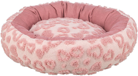 Rundes, flauschiges, rosa Bett mit Herzmuster und erhöhter Umrandung.