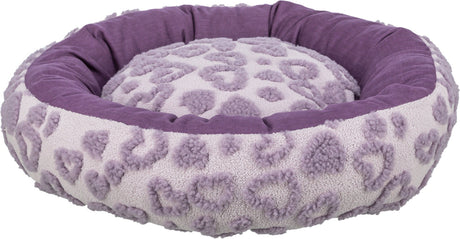 Rundes, flauschiges Liegebett in Lila mit einem Muster aus herzförmigen Erhebungen auf der Oberseite.