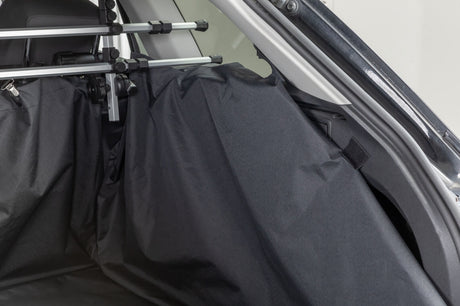 Schwarze Autoschondecke im Kofferraum mit Metallhalterungen befestigt.