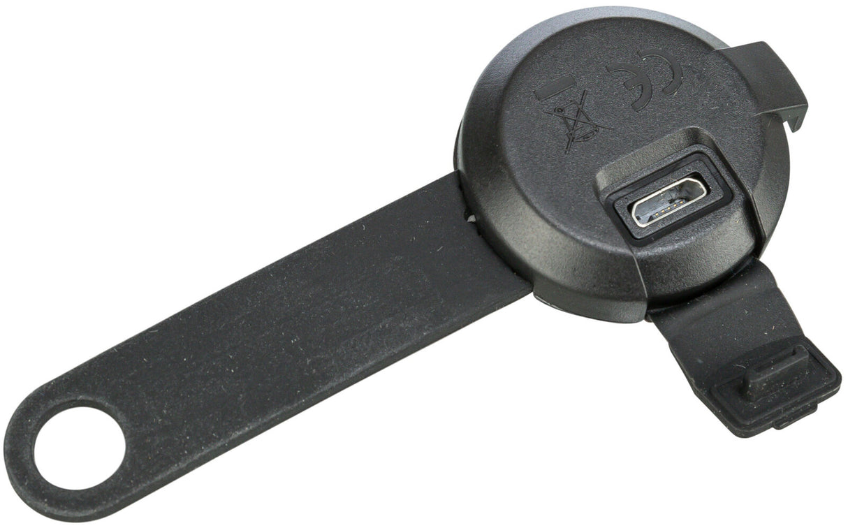 Schwarzes Kunststoffgerät mit rundem Deckel, USB-Anschluss und langem Griff mit Öse, Symbolen oben.