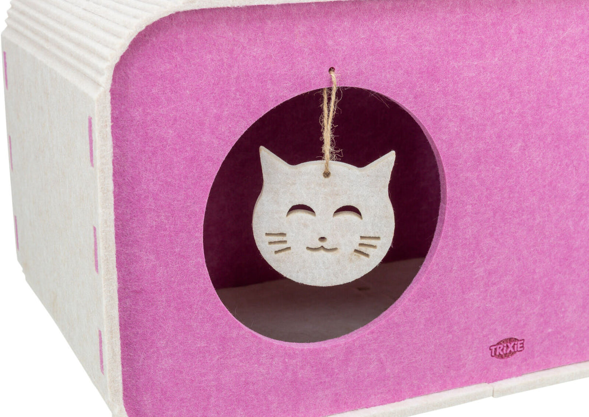 Kartonförmiger pink-weißer Behälter mit runder Öffnung und hängendem Katzenmotiv, Marke Trixie sichtbar.