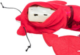 Rotes Plüschspielzeug in der Form eines Hummers mit einem weißen Kunststoffkasten und Kabel, sichtbar in der Öffnung.